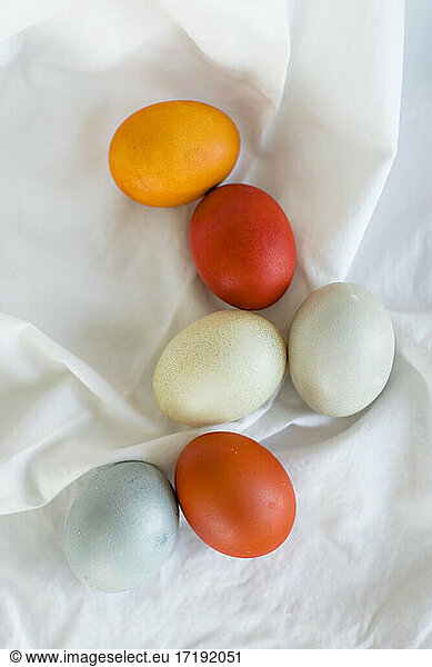 Naturally dyed orange  yellow  and blue Easter Eggs in a layflat