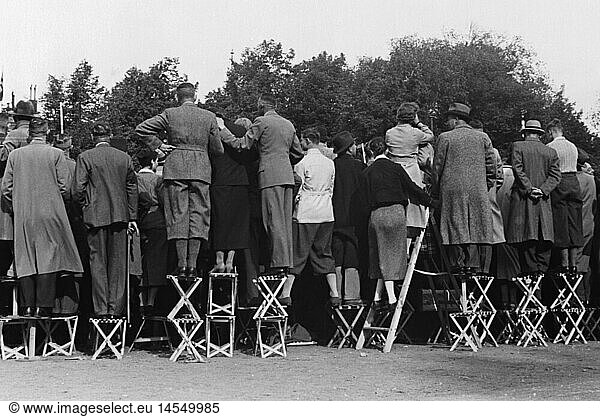 Nazism / National Socialism  politics  Axis Rome-Berlin  journey of Prime Minister Benito Mussolini to Germany 25.- 29.9.1937  arrival in Berlin  viewers at the roadside from behind  27.9.1937  crowd  crowds  crowds of people  chairs  chair  axis Rome - Berlin  fascism  state visit  state visits  foreign policy  external policy  German Reich  Third Reich  1930s  30s  20th century  politics  policy  viewers  viewer  historic  historical