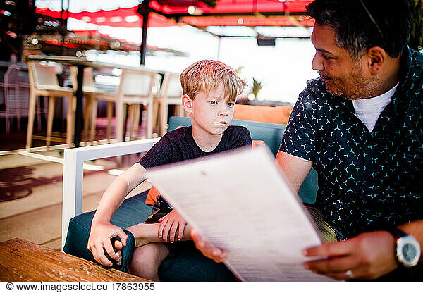 Nephew & Uncle Looking at Menu at Restaurant in San Diego