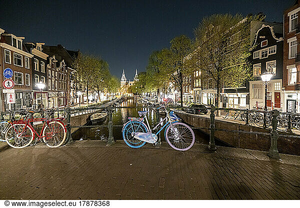 Netherlands  North Holland  Amsterdam  Bicycles left along canal bridge at night