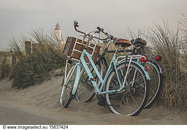 Netherlands  South Holland  Noordwijk  bicycles on sandy beach and lighthouse
