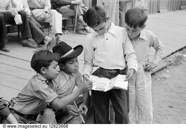 NEW MEXICO: GOLD MINE  1940. Miners' children reading comic books in Mogollon  New Mexico. Photograph by Russell Lee  1940.