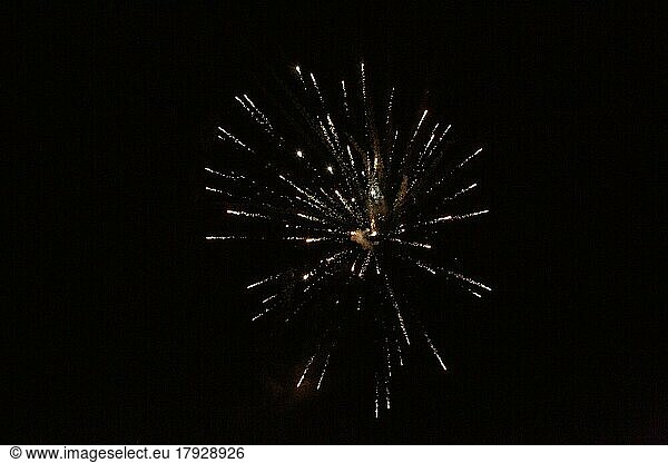 New Year's Eve fireworks night sky with yellow and golden sparks