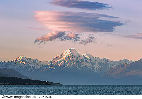 New Zealand  Canterbury  Majestic Mount Cook towering over blue waters of Lake Pukaki at sunset