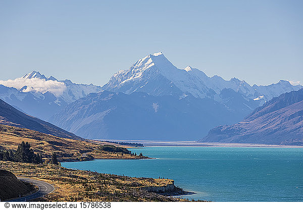 New Zealand  Clear sky over turquoise shore of Lake Pukaki with Mount Cook looming in background