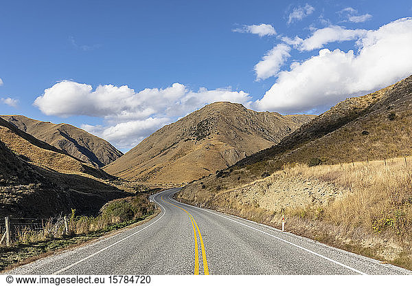 New Zealand  Clouds over empty State Highway 8 in Lindis Pass