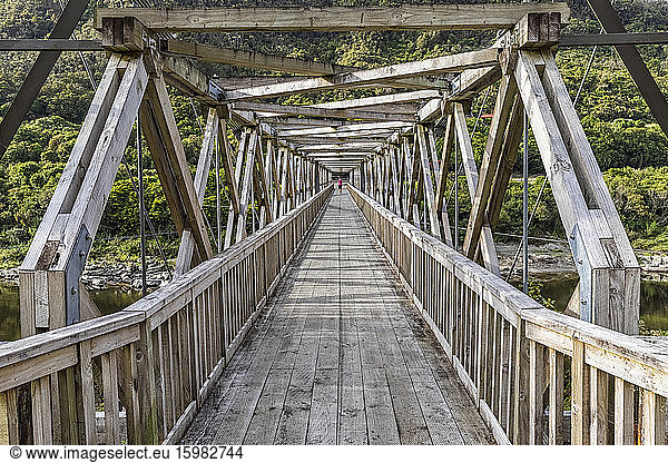 New Zealand  Diminishing perspective of wooden bridge at Brunner Mine site