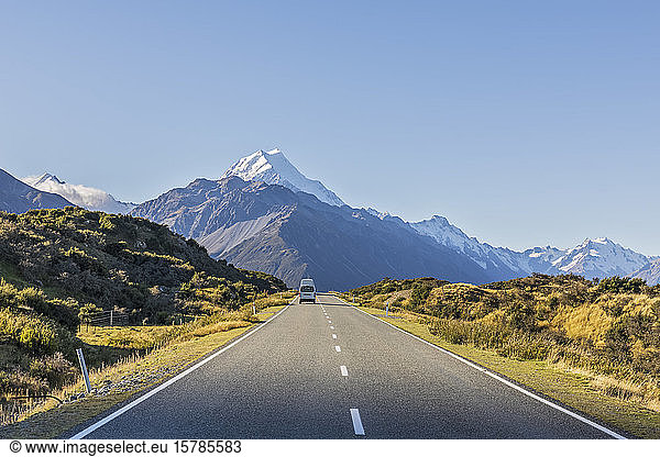 New Zealand  Oceania  South Island  Canterbury  Ben Ohau  Southern Alps (New Zealand Alps)  Mount Cook National Park  Mount Cook Road and Aoraki / Mount Cook  Camper on road in mountain landscape