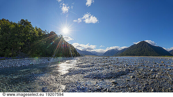 New Zealand  South Island New Zealand  Sun shining over Waimakariri River in Arthurs Pass National Park