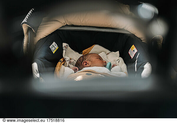 Newborn baby sleeping in his carriage.