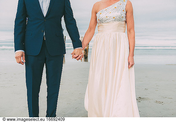Newlyweds Holding Hands Beach Wedding