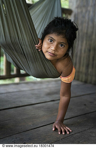 Nicaragua  San Juan de Nicaragua. Portrait of a 7-year-old Rama girl in a hammock living along the Rio Indio river.