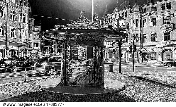 Night shot  black and white photo of an old advertising pillar at Schillerplatz  car traffic  Blasewitz  Dresden  Saxony  Germany  Europe