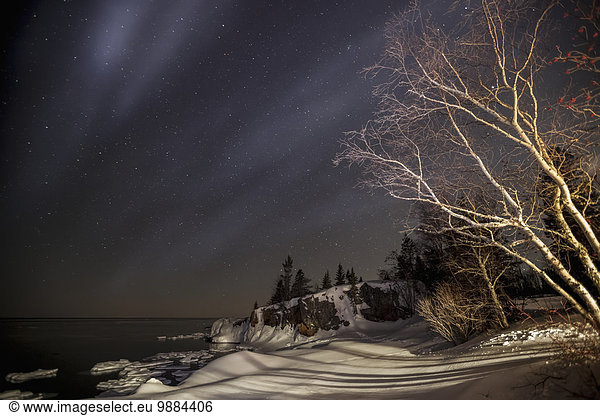 Night sky with stars and Lake Superior in winter; Grand Portage  Minnesota  United States of America