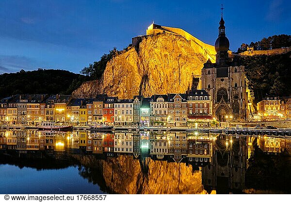 Night view of Dinant town  Collegiate Church of Notre Dame de Dinant over River Meuse and Pont Charles de Gaulle bridge and Dinant Citadel illuminated in the evening  Dinant  Belgium