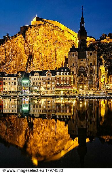 Night view of Dinant town  Collegiate Church of Notre Dame de Dinant over River Meuse and Pont Charles de Gaulle bridge and Dinant Citadel illuminated in the evening. Dinant  Belgium