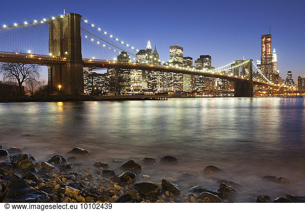 Night view towards Manhattan from Brooklyn  with the Brooklyn Bridge spanning the East River.