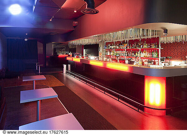 Nightclub interior  hospitality venue and colourful lighting  large bar.