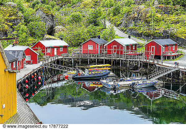 Norway  Nordland  Nusfjord  Motorboats moored in front of coastal stilt houses