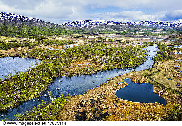 Norway  Troms og Finnmark  Drone view of Lakselva river flowing through moor on Senja island