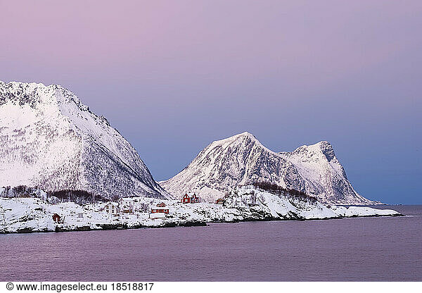 Norway  Troms og Finnmark  Secluded huts on snow covered shore of Senja Island