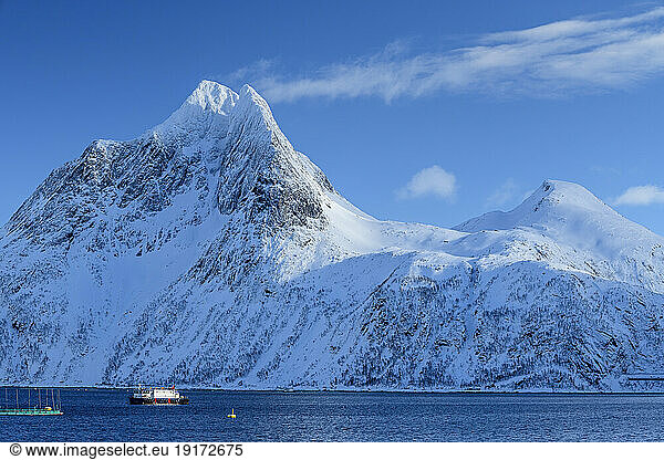 Norway  Troms og Finnmark  Ship sailing along Mefjord with Breidtind mountain in background