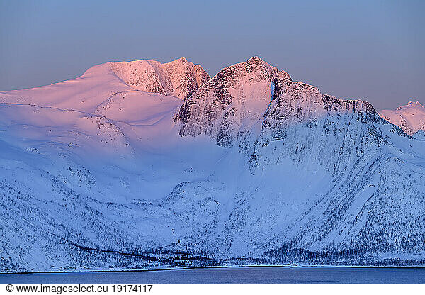 Norway  Troms og Finnmark  Snowcapped mountains surrounding Mefjord at dusk