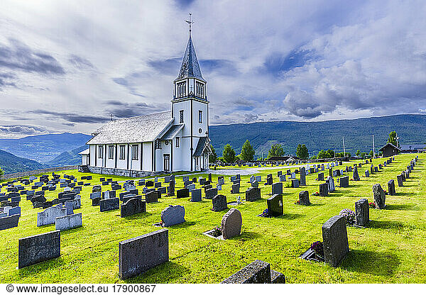Norway  Viken  Gol  Rows of tombstones with rural church in background