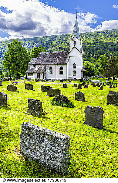 Norway  Viken  Torpo  Cemetery tombstones with rural church in background
