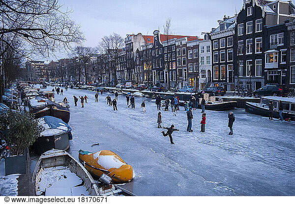 Numerous people ice skating on the canals; Amsterdam  Netherlands