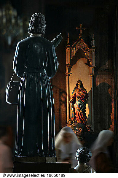Nuns and statues in San Sebastian Basilica  Manila  Philippines