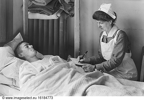 Nurse writing a Letter Home for a wounded American Soldier at the American Military Hospital No. 1  Neuilly  France  Lewis Wickes Hine  American National Red Cross Photograph Collection  June 1918
