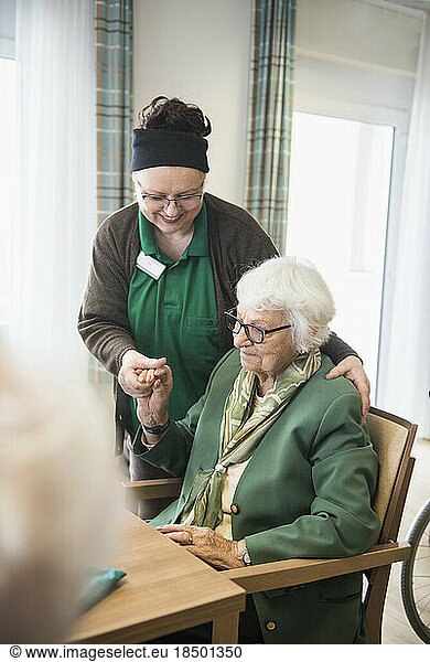 Nursing staff caring about Senior woman in rest home