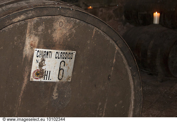 Oak barrel of Chianti wine in cellar in Tuscany.