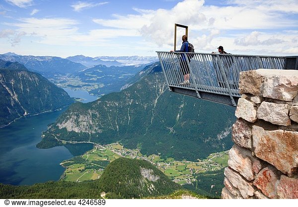 Obertraun  Salzkammergut  Austria  Europe People on 5fingers viewing platform on Krippenstein mountain at the Dachstein World Heritage site with high view to Hallstattersee lake 400 metres below in the Austrian Alps