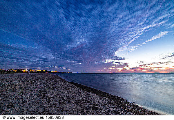 Ocean shoreline long exposure and night clouds.