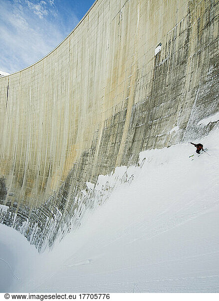 Off Piste Skier Skiing The Walls Of The Moiry Dam; Zinal  Switzerland