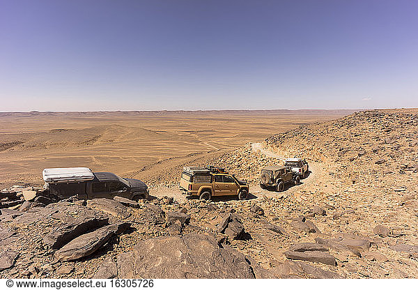 Off-road cars traversing rocky desert terrain
