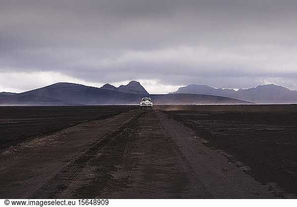 Off road vehicle on dirt track heading to hills Landmannalaugar Iceland
