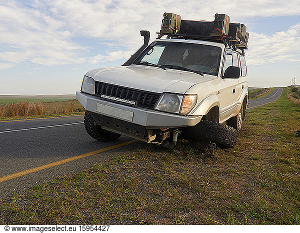 Off-road vehicle with flat tyre at  the side of the road. South Africa