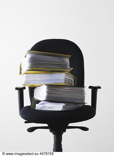 Office chair with stack of files