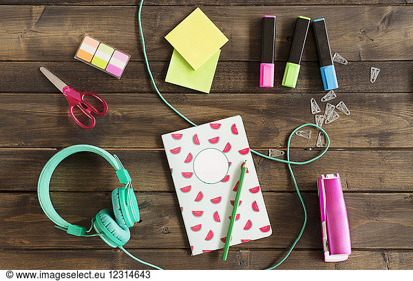 Office supplies and headphones on desk