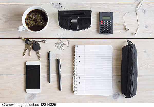 Office supplies  smart phone  keys and coffee cup on desk