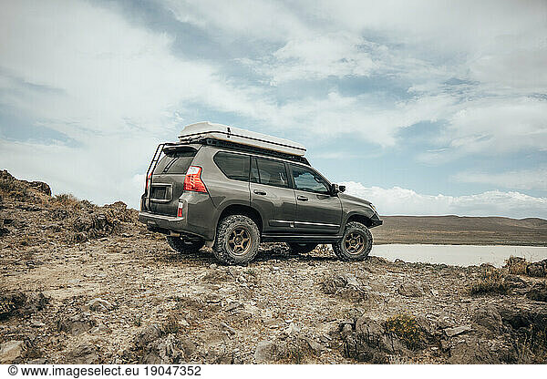 Offroad vehicle on rough terrain in desert
