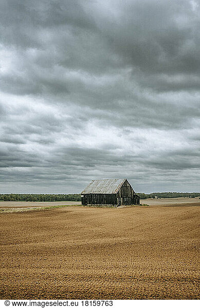 Old abandoned weathered barn in middle of Kentucky farm field