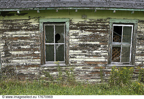 Old Barn with Two Broken Windows and Peeling Paint