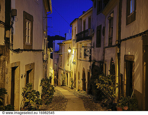 Old cobble stone lined village street in Castelo De Vide at night
