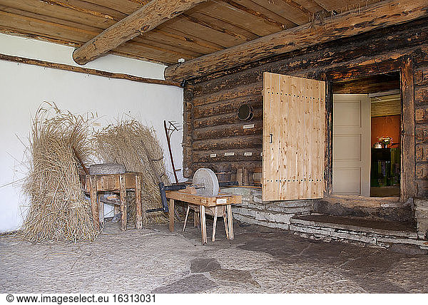 Old Fashioned Cabin porch With a Sharpening Stone