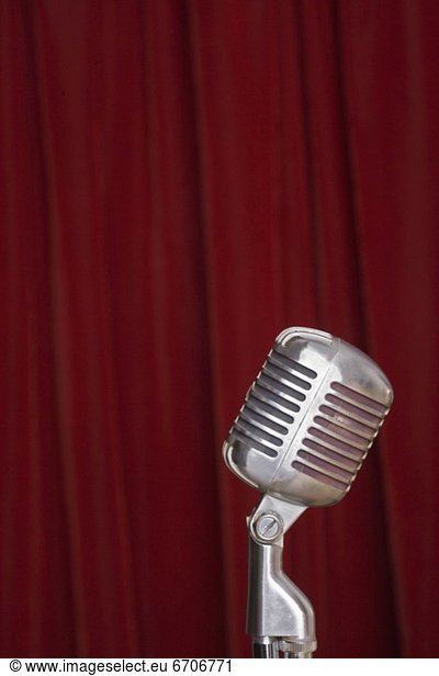 Old fashioned microphone with red curtain