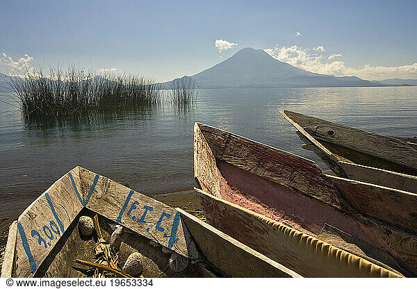 Old fishing boatsrest on the shore of Lake Atitlan  Guatemala